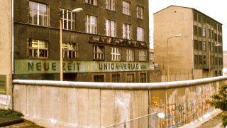 Exterior_of_East_Berlin_Neue_Zeit_newspaper,_with_Berlin_Wall_in_foreground