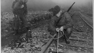 Commandoes_of_the_41st_Royal_British_Marines_plant_demolition_charges_along_railroad_tracks_of_enemy_supply_line..._-_NARA_-_520790.tif
