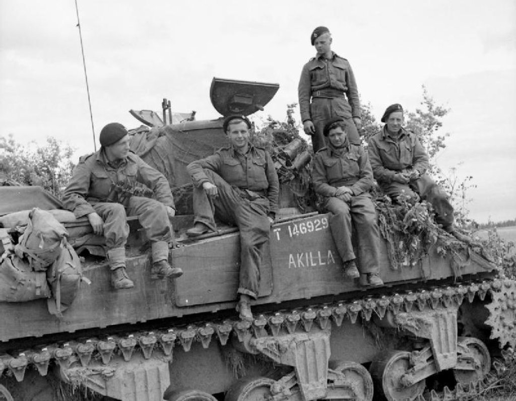 The_crew_of_a_Sherman_tank_named_'Akilla'_of_1st_Nottinghamshire_Yeomanry,_8th_Armoured_Brigade,_after_having_destroyed_five_German_tanks_in_a_day,_Rauray,_Normandy,_30_June_1944._B6222