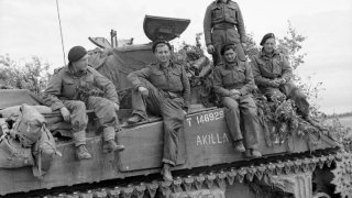 The_crew_of_a_Sherman_tank_named_'Akilla'_of_1st_Nottinghamshire_Yeomanry,_8th_Armoured_Brigade,_after_having_destroyed_five_German_tanks_in_a_day,_Rauray,_Normandy,_30_June_1944._B6222