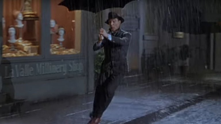 8. Gene Kelley - Singin' in the rain
Един мъж, един чадър, една песен. Подгизналият, но щастлив герой на Джийн Кели в мюзикъла "Аз пея под дъжда" е олицетворение на това как песен и филм могат да бъдат възприемани като едно. В случая песента е написана десетилетия преди премиерата на мюзикъла през 1952-а, но в крайна сметка става популярна в световен мащаб именно благодарение на него и образа на пляскащия доволно в гьоловете Кели.