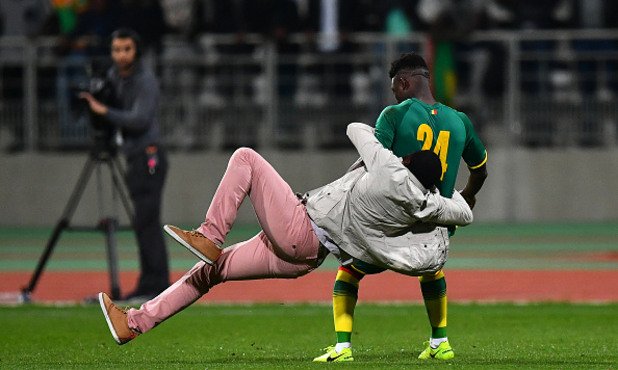 Един от феновете дори сграбчи и събори футболиста на Сенегал Ламине Гасана.