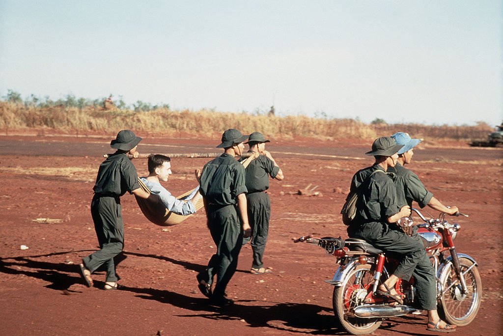 1024px-VC_carrying_POW_in_litter_DD-ST-99-04295