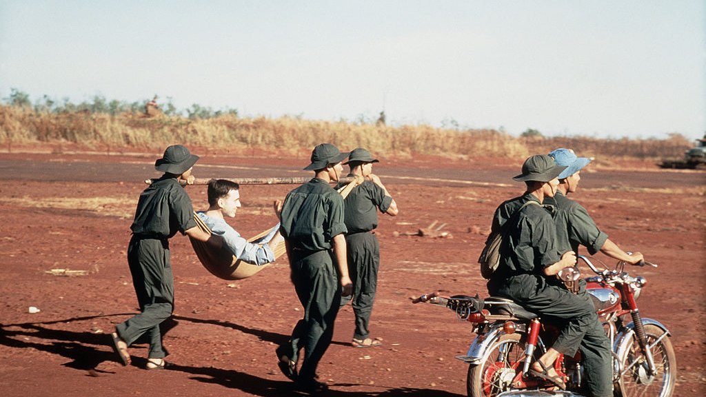 1024px-VC_carrying_POW_in_litter_DD-ST-99-04295