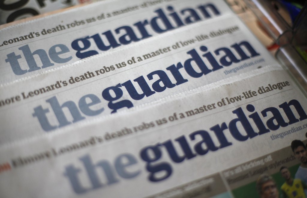 Copies of the Guardian newspaper are displayed at a news agent in London
