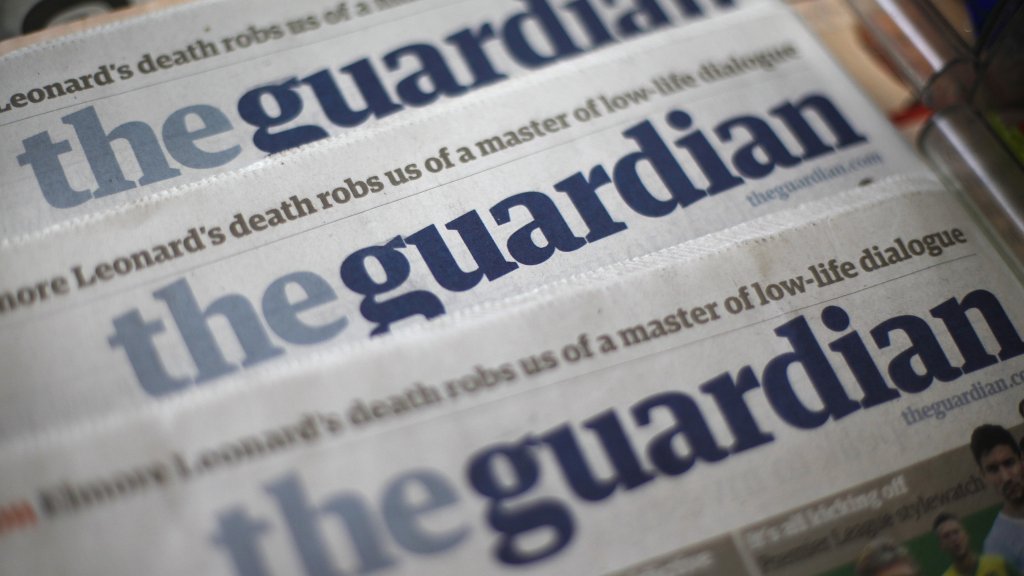 Copies of the Guardian newspaper are displayed at a news agent in London