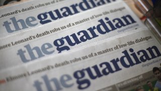 Copies of the Guardian newspaper are displayed at a news agent in London