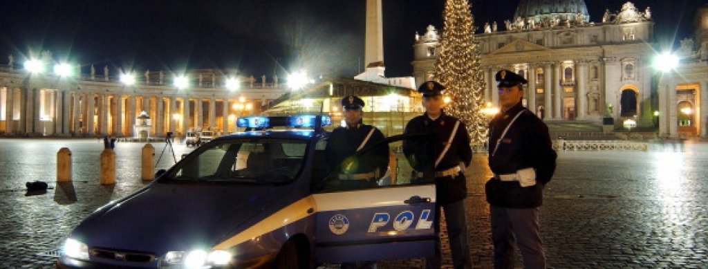 Italian policemen during a patrol in front of Saint Peter's basilica at night in Rome, Italy on December 17th, 2003.