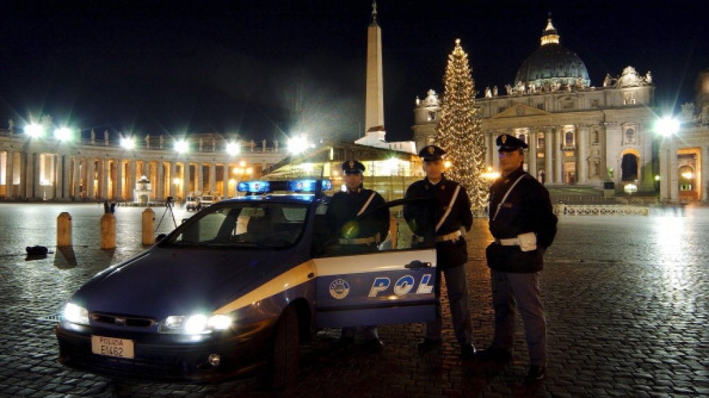 Italian policemen during a patrol in front of Saint Peter's basilica at night in Rome, Italy on December 17th, 2003.