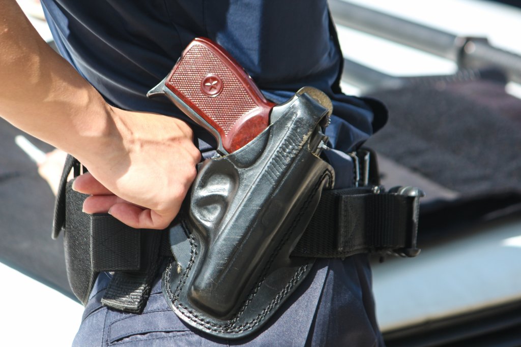 A woman with a Macarov gun in a black holster.