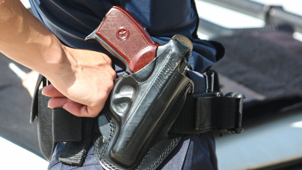 A woman with a Macarov gun in a black holster.