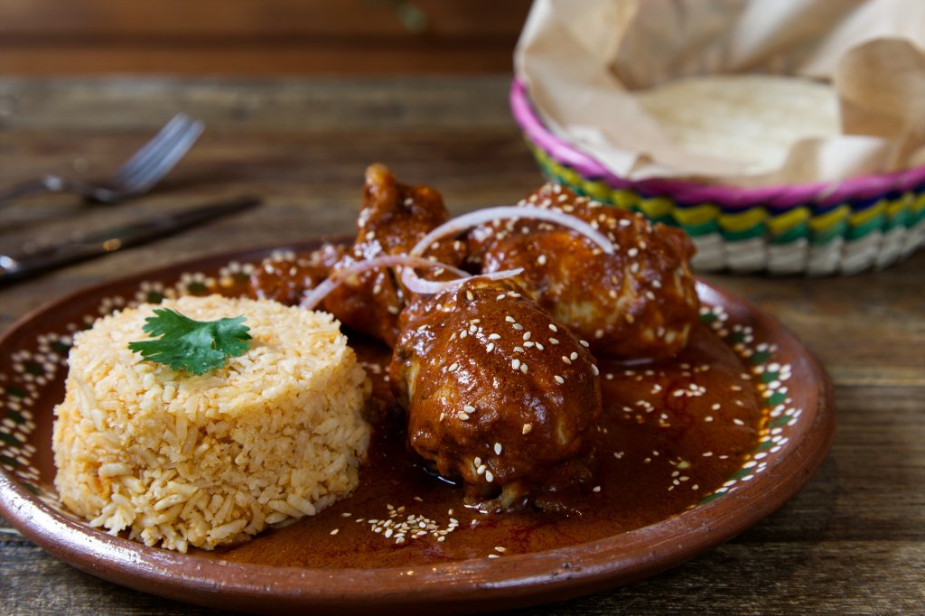 Пиле МолеПиле с шоколад - мексиканците знаят как. Запържете пилешко по ваш избор - бутчета, крилца или филе и извадете в чиния. В същия тиган запържете една голяма глава лук, нарязана на ситно, подправен с лют червен пипер, куркума, кимион и сух кориандър. След това изсипвате 400 грама домати от консерва и чаша пилешки бульон и варите до сгъстяване.
Изпечете пилето до готовност за 25-30 минути и го разпределете в чиниите, в които ще сервирате. Загрейте отново соса и в него прибавете 80 грама висококачествен черен шоколад, изчакайте да се разтопи и пасирайте до гладкост. Залейте пилешкото със соса и поръсете със сусам. Сервирайте с картофено пюре или ориз.