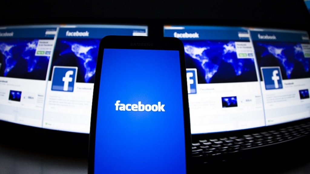 The loading screen of the Facebook application on a mobile phone is seen in this photo illustration taken in Lavigny