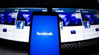 The loading screen of the Facebook application on a mobile phone is seen in this photo illustration taken in Lavigny