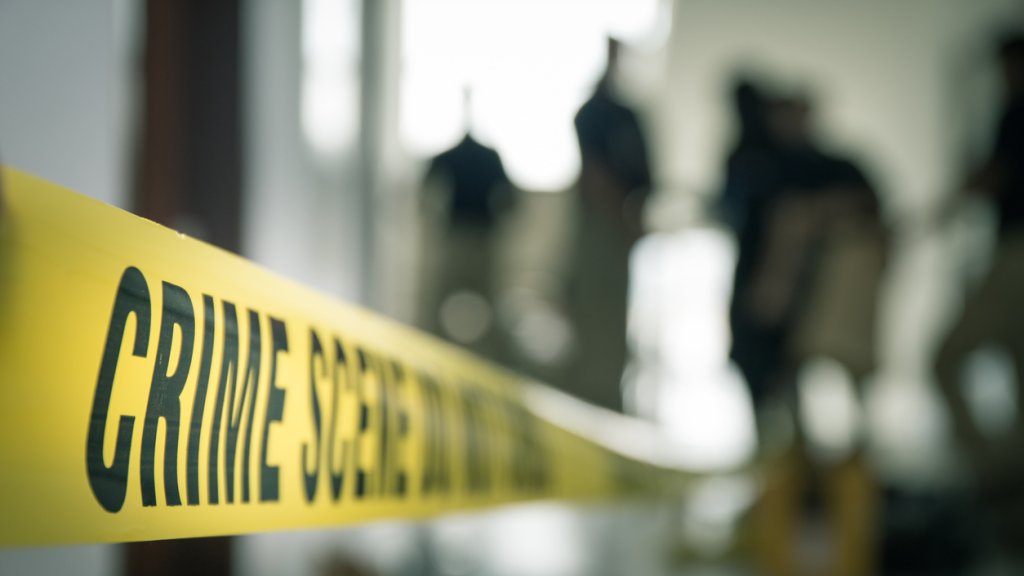 crime scene tape with blurred forensic in cinematic tone