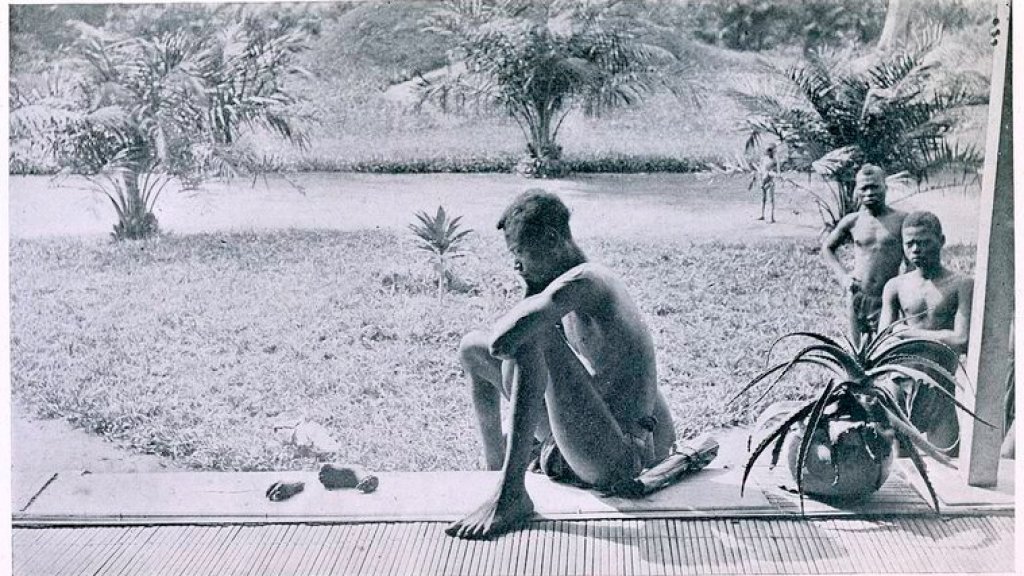 Nsala_of_Wala_in_Congo_looks_at_the_severed_hand_and_foot_of_his_five-year_old_daughter,_1904