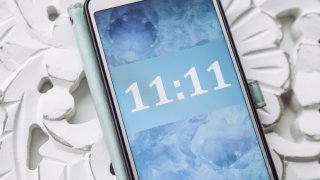 Person looking and seeing similar numbers. Seeing same similar numbers is called Angel numbers. Angels sending cryptic messages and communicating concept.