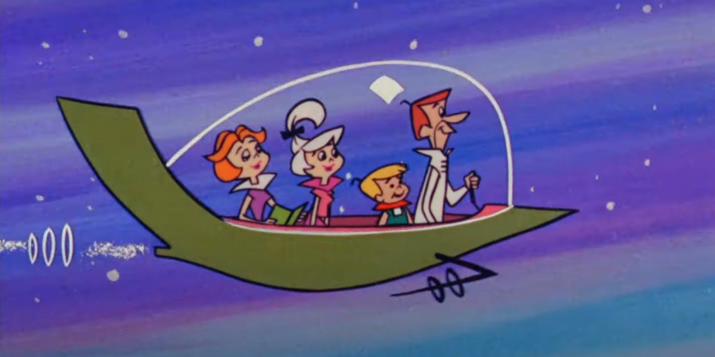 The Jetsons/ ”Семейство Джетсън”
Макар и видимо да използва същата формула като “Семейство Флинтстоун”, историята на “Семейство Джетсън” става не по-малко популярна, а един от най-известни кросоувъри в телевизията е именно между двете семейства, които разменят местата си във времето.
Най-интересното от днешна гледна точка е начинът, по който през 60-те са си представяли бъдещето с летящи коли и градове във въздуха.