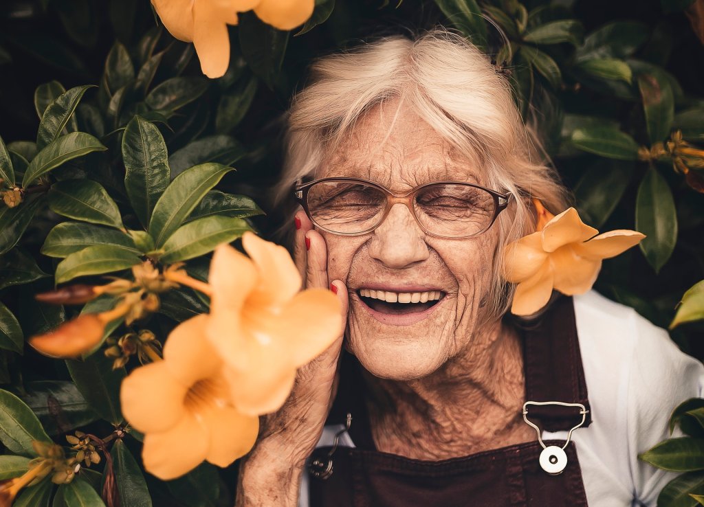 woman-standing-near-yellow-petaled-flower-2050994