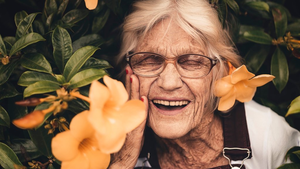 woman-standing-near-yellow-petaled-flower-2050994
