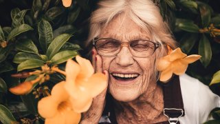 woman-standing-near-yellow-petaled-flower-2050994