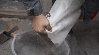 Construction worker pouring the cement to the bucket