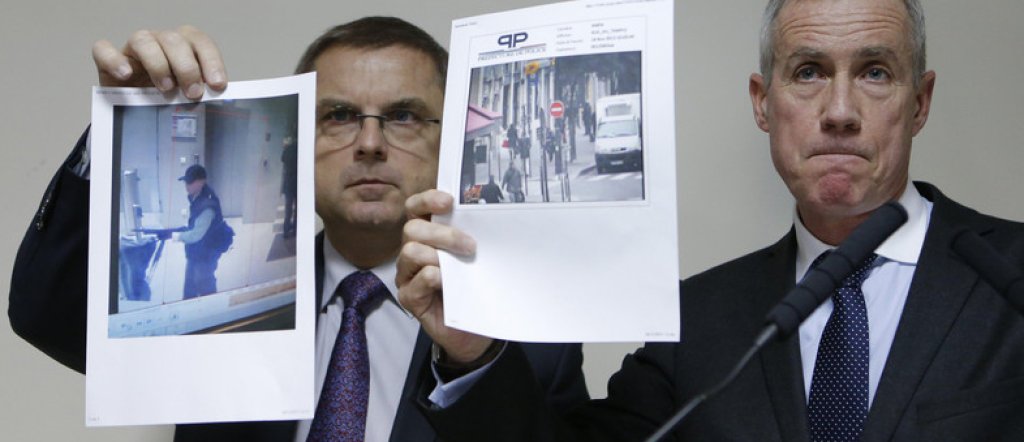 Paris prosecutor Molins and director of the Paris' judiciary police Flaesch show two photographs of the suspect gunman taken from surveillance footage  during a news conference in Paris