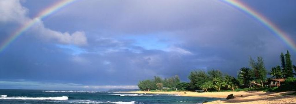 Double rainbow and evening light on beach. Kauai Island. Hawaii. USA