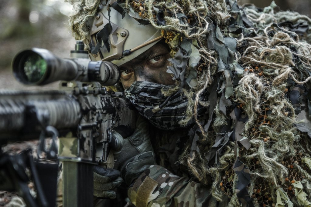 sniper wearing ghillie suit