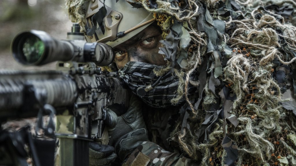 sniper wearing ghillie suit