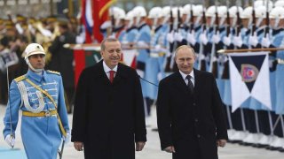 Russia's President Putin and Turkey's President Erdogan review a guard of honour during a welcoming ceremony in Ankara