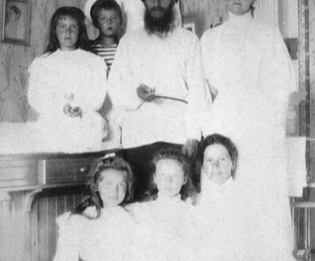 Empress Alexandra Feodorovna with Rasputin, her children and a governess.