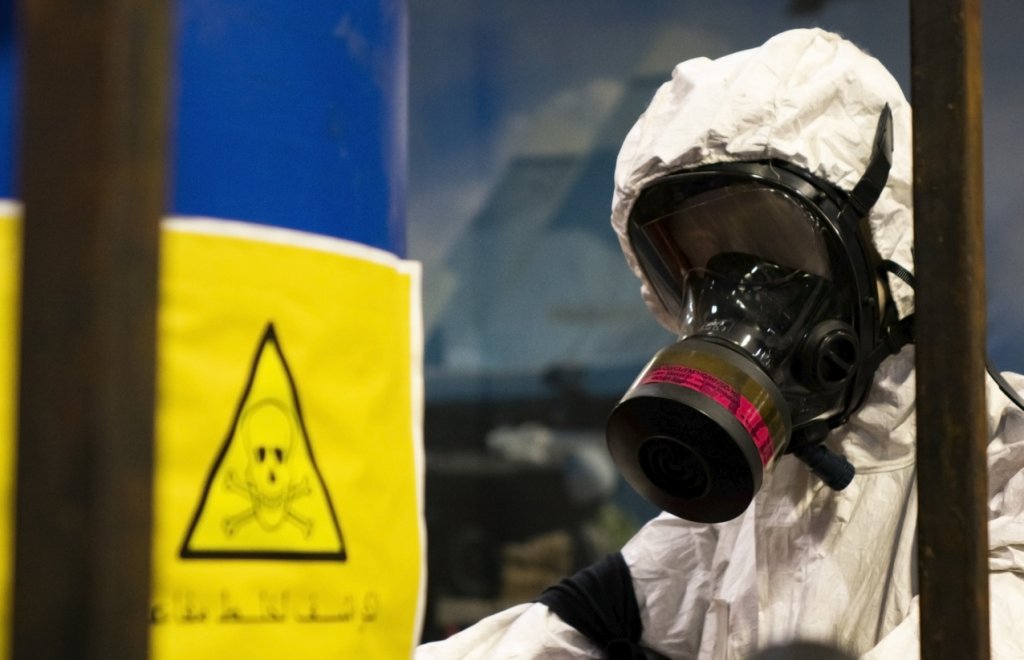 People in protective suits in the laboratory for the production of chemical and biological weapons.