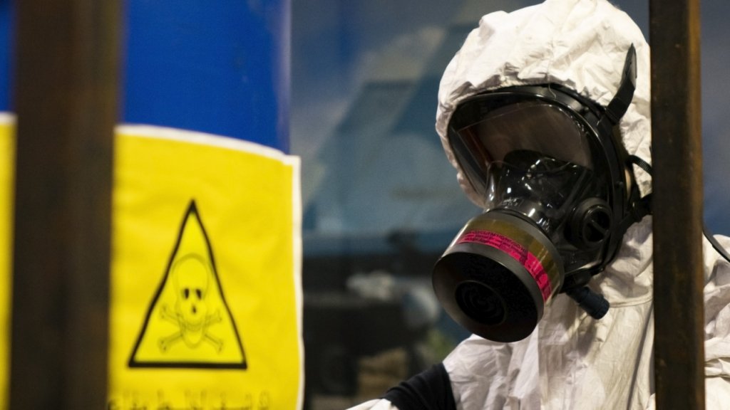 People in protective suits in the laboratory for the production of chemical and biological weapons.
