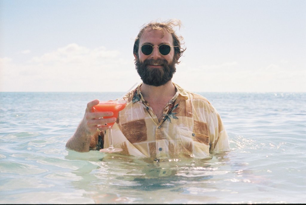 man-drinking-cocktail-in-sea-527588079-570f23bd5f9b5814089738fc