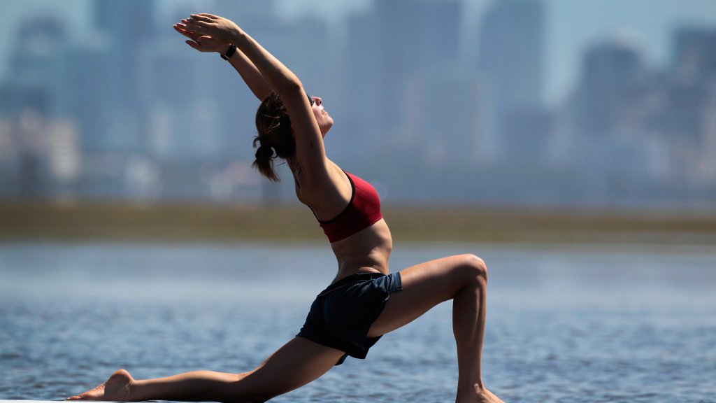 Practioners Enjoy Serenity Of Paddleboard Yoga
