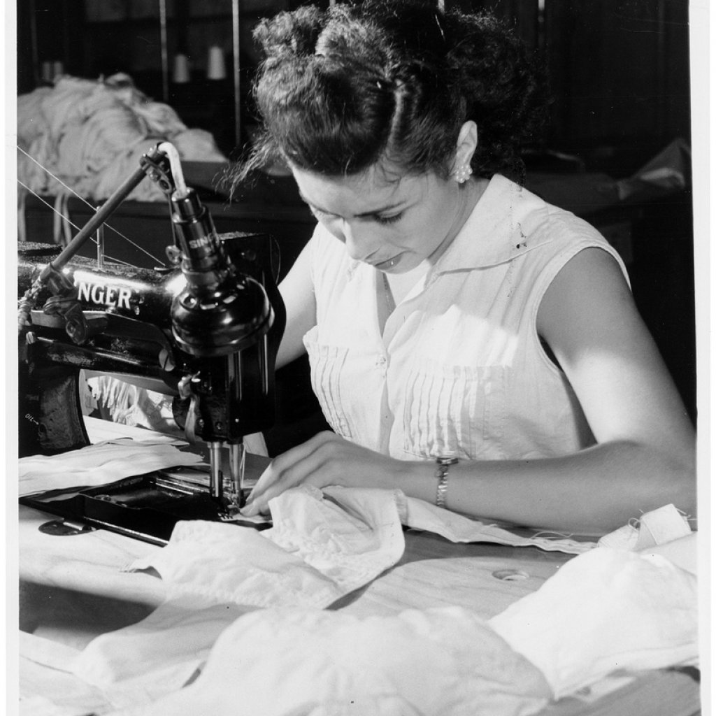 Woman_sewing_in_a_Puerto_Rico_garment_shop