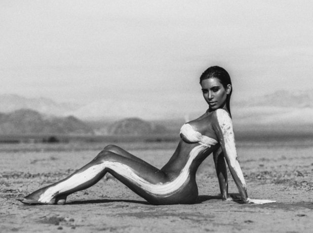 На снимките Кардашиян позира напълно гола, като само на места тялото й е намазано с ярка боя