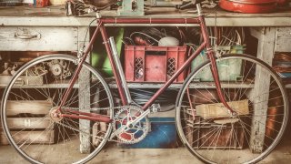 Vintage racing bycicle in front of an old work bench with tools