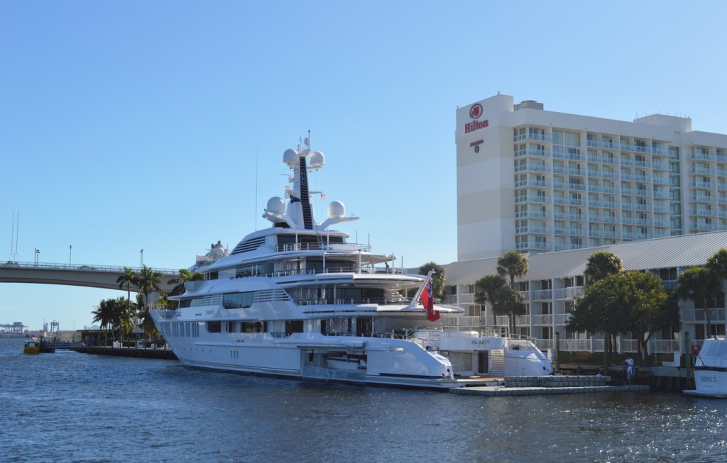 Luxurious Infinity England yacht docked on the side of the canals near Hilton Hotel