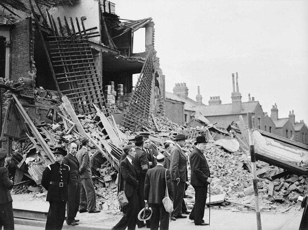 1280px-Winston_Churchill_visiting_bomb-damaged_areas_of_the_East_End_of_London,_8_September_1940._H3978