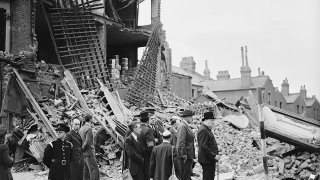 1280px-Winston_Churchill_visiting_bomb-damaged_areas_of_the_East_End_of_London,_8_September_1940._H3978