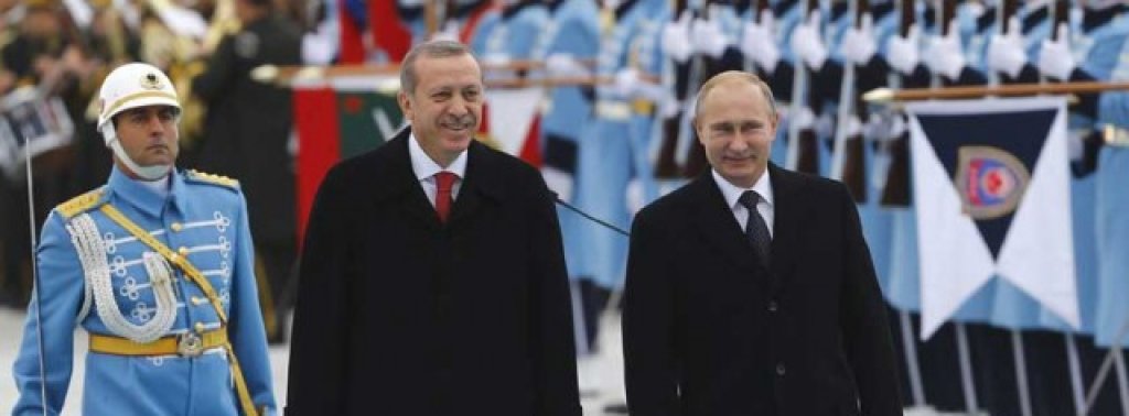 Russia's President Putin and Turkey's President Erdogan review a guard of honour during a welcoming ceremony in Ankara