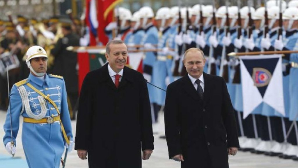 Russia's President Putin and Turkey's President Erdogan review a guard of honour during a welcoming ceremony in Ankara