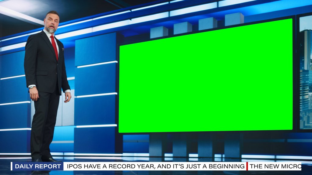 Talk Show TV Program: Handsome White Male Presenter Standing in Newsroom Studio, Uses Big Green Chroma Key Screen. News Achor, Presenter Talks About News, Weather. Mock-up of Cable Channel