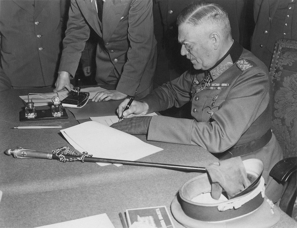 1280px-Field_Marshall_Keitel_signs_German_surrender_terms_in_Berlin_8_May_1945_-_Restoration