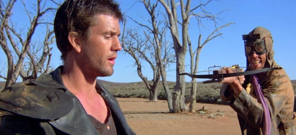 Mad Max 2: The Road Warrior / „Лудия Макс 2: Воин на пътя“
Втората част на “Лудия Макс” по същия начин надгражда над своя предшественик като извлича най-доброто от него и в същото време добавя още. Става въпрос за един жесток постапокалиптичен свят на бъдещето, където практически не съществува граница между добро и зло, а целта винаги оправдава средствата. В повечето случаи целта е самото оцеляване на фона на тотален социален разпад на човечеството.
За цялото десетилетие едва ли има по-високоадреналинов филм, като за това допринася особено много една от най-великите сцени на преследване с коли, включваща невиждани дотогава каскади на висока скорост.