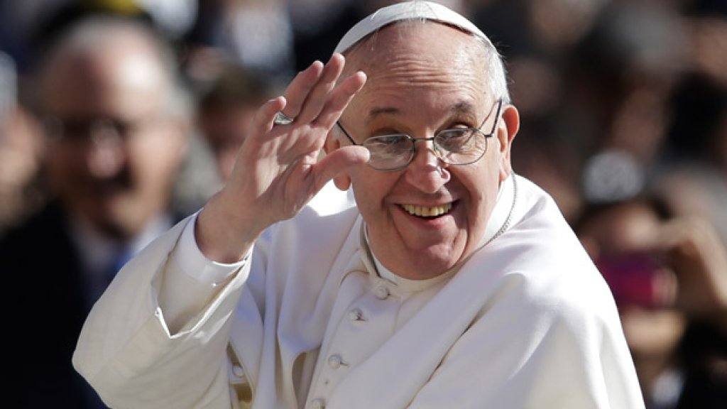 Pope Francis waves to crowds as he arrives to his inauguration mass on 19 March 2013.