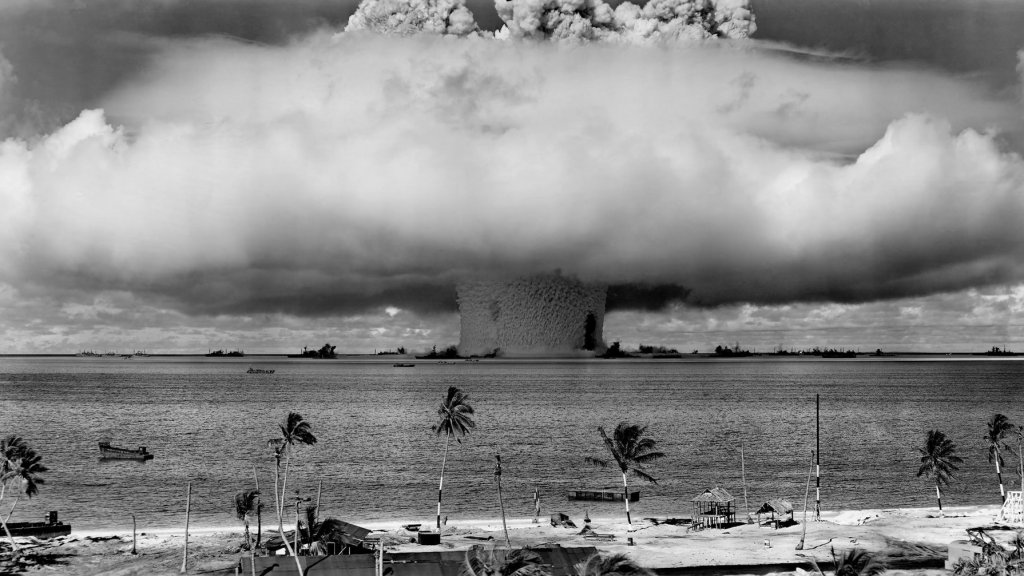 grayscale-photo-of-explosion-on-the-beach-73909