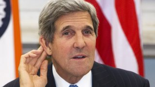 U.S. Secretary of State Kerry gestures as he asks reporter to repeat question during news conference with Indian Foreign Minister Khurshid at Hyderabad House in New Delhi